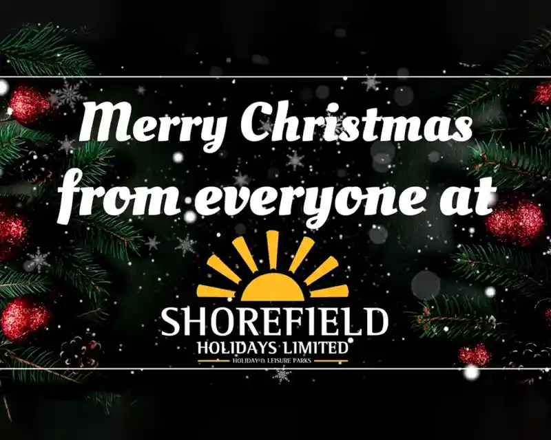 Merry Christmas greeting surrounded by festive decorations, including pine branches and ornaments, with a sun logo for Shorefield Holidays Limited at the bottom.