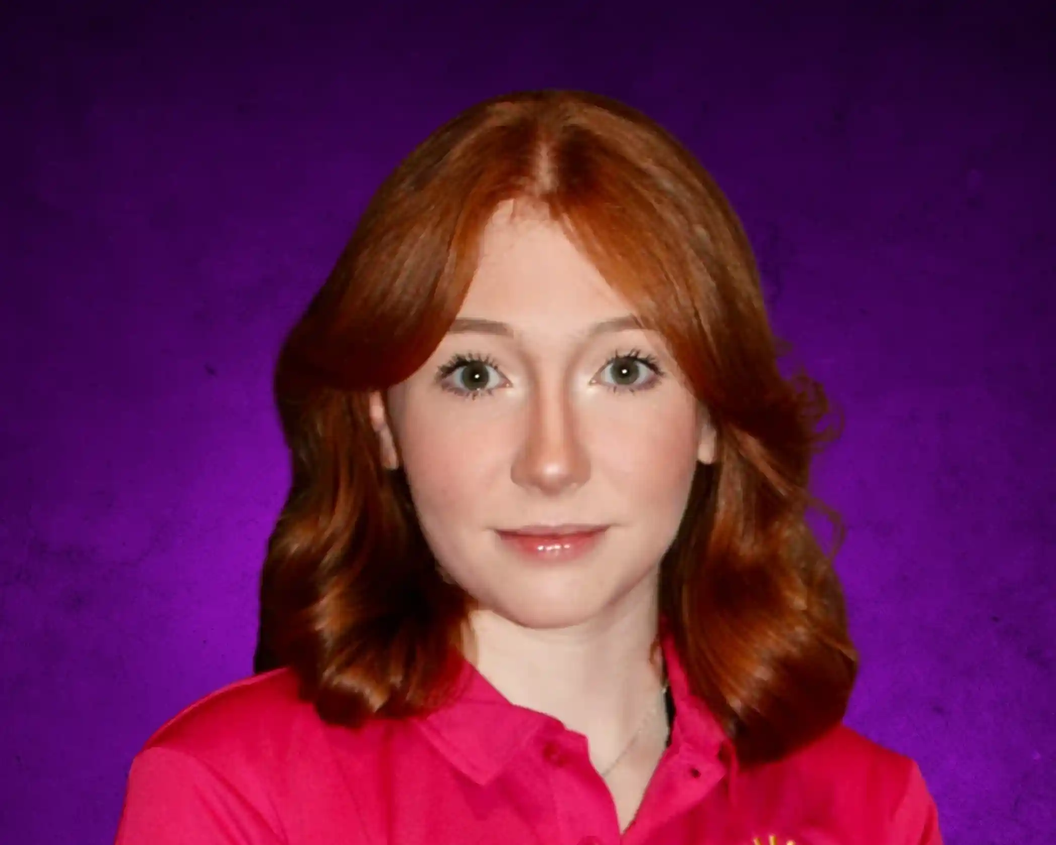 A young woman with wavy red hair and green eyes smiles softly, wearing a bright pink shirt against a purple background.