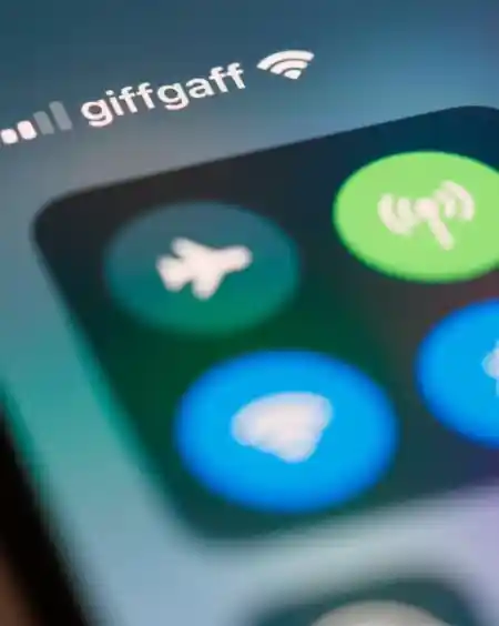 Close-up of a smartphone screen showing the control center with WiFi, Bluetooth, and airplane mode icons, and 'giffgaff' displayed as the mobile network provider with a WiFi connection icon.