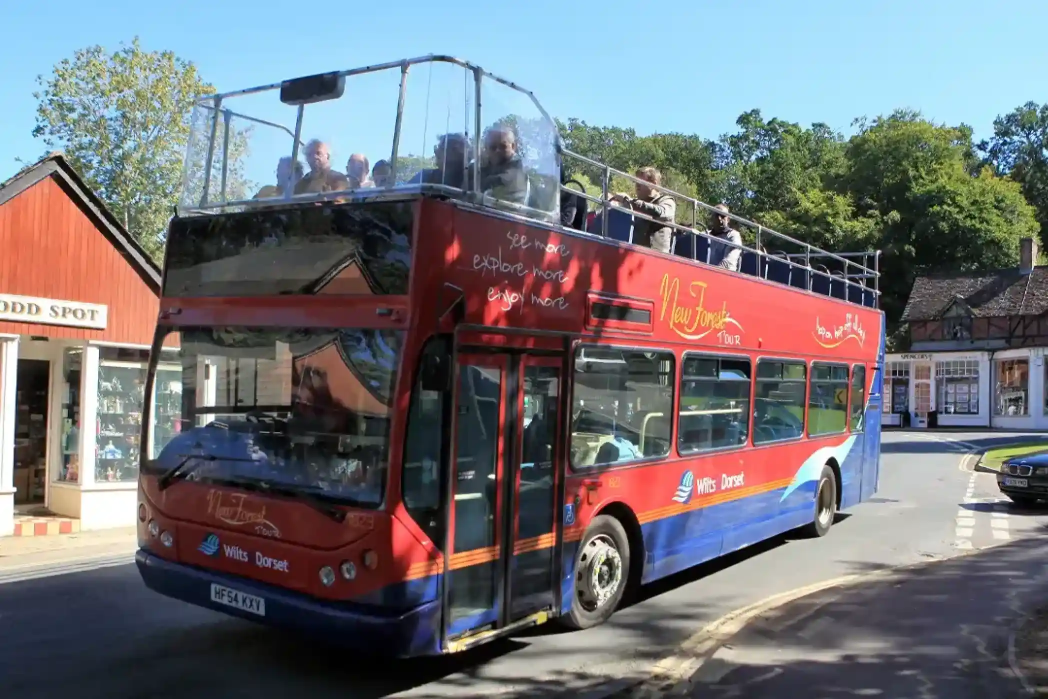 Open-top red and blue double-decker bus labelled 