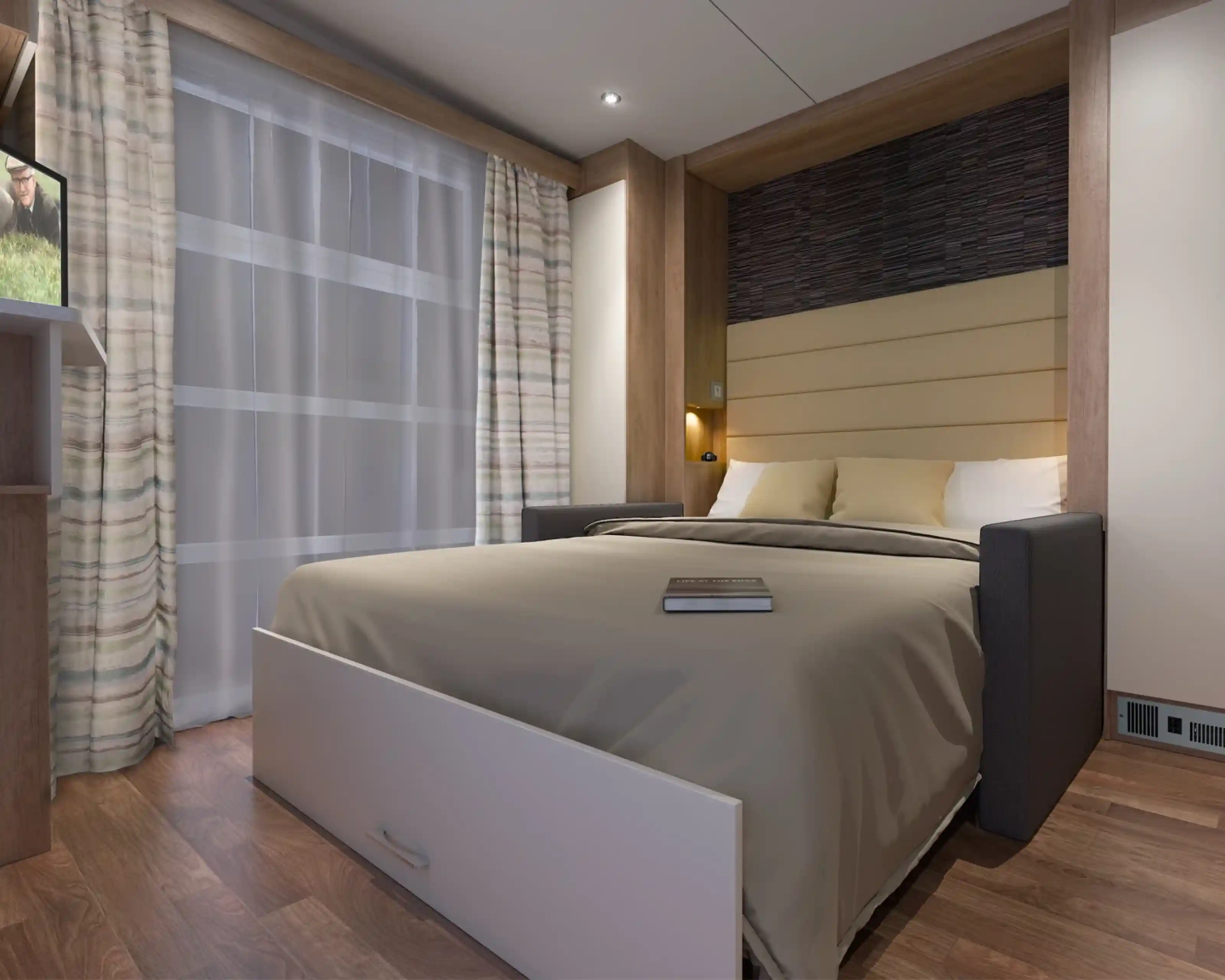 A cozy bedroom featuring a platform bed with a gray and beige color scheme. The backdrop has wood paneling and soft lighting. A small bookshelf is visible with a book resting on the bed. Sheer curtains let in natural light, and the flooring is made of warm-toned wood.
