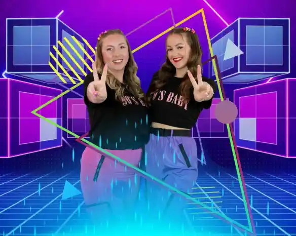 Two young women pose playfully, making peace signs with their fingers. They wear matching outfits with the phrase "90's Baby" printed on their shirts. The background features vibrant geometric shapes and neon colors, creating a retro-inspired theme.