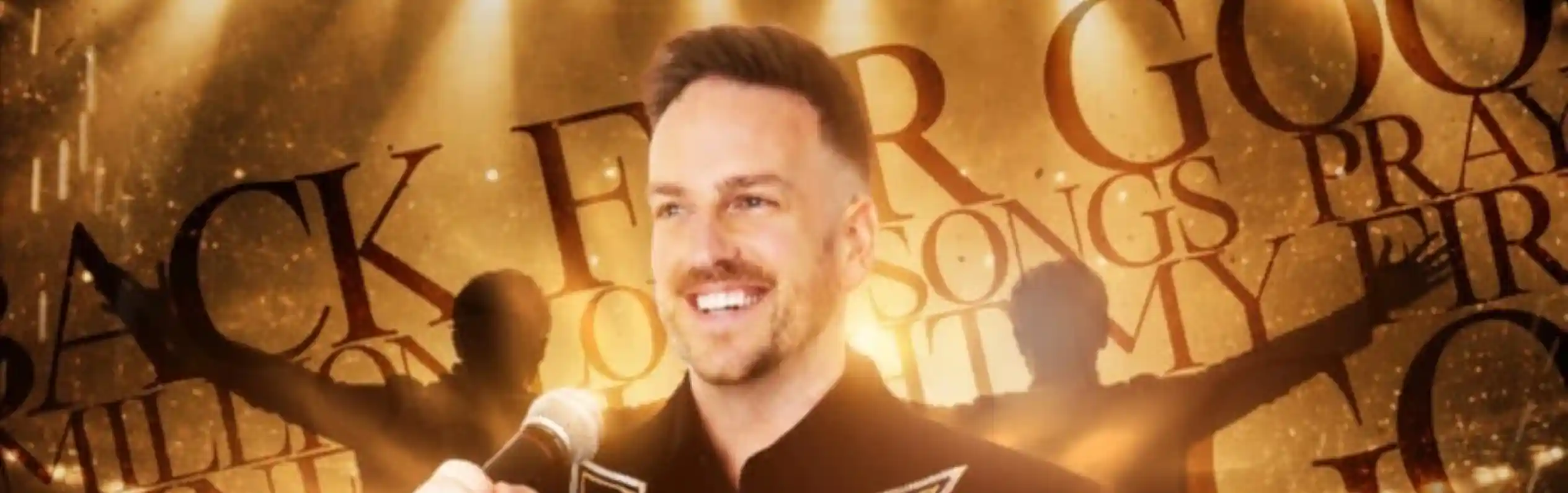 A smiling performer in a flashy jacket stands with a microphone on stage, illuminated by bright lights. The background features the words "Back for Good" and "songs," creating an energetic atmosphere.