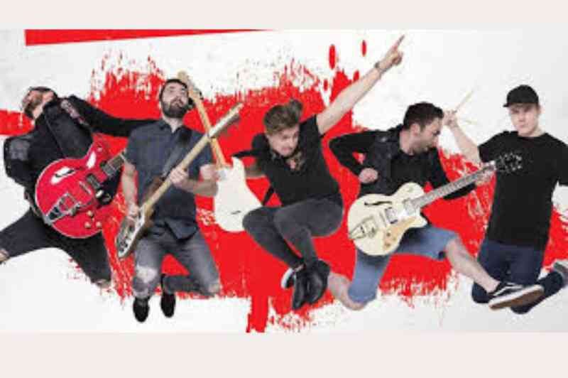 A group of five male musicians jumping in the air, each holding different instruments, including guitars and drums. They are set against a vibrant red and white abstract background.