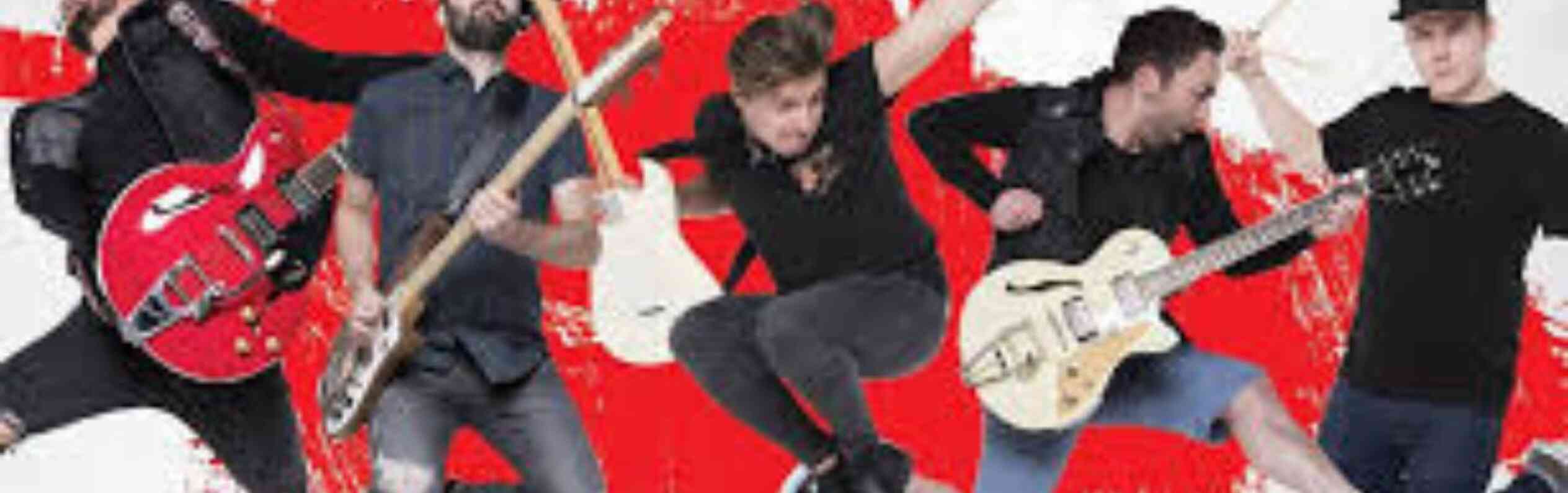 A group of five male musicians jumping in the air, each holding different instruments, including guitars and drums. They are set against a vibrant red and white abstract background.