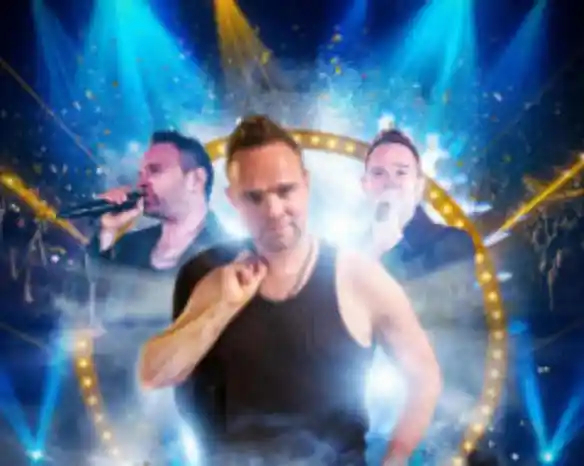 A performer stands confidently in front of a colorful stage backdrop featuring bright lights and sparkling confetti. Behind him, two images of him singing are layered, creating a dynamic effect. He wears a black tank top and sports a stylish hairstyle.