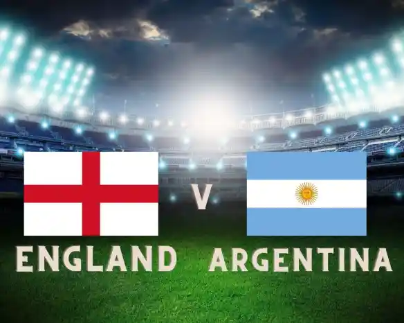 English and Argentinian flags displayed with "England v Argentina" text on a grassy soccer field under stadium lights.