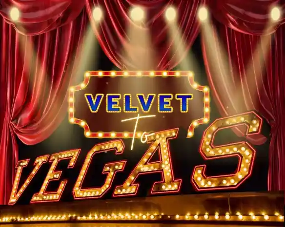 A bright marquee sign reading "Velvet to Vegas" illuminated by lights, set against a backdrop of rich red curtains. Spotlights shine on the sign, creating a vibrant theatrical atmosphere.