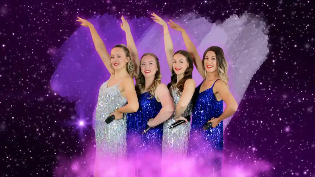 Four women in shimmering sequined dresses pose against a cosmic purple background, each holding a microphone and raising one arm with bright smiles.