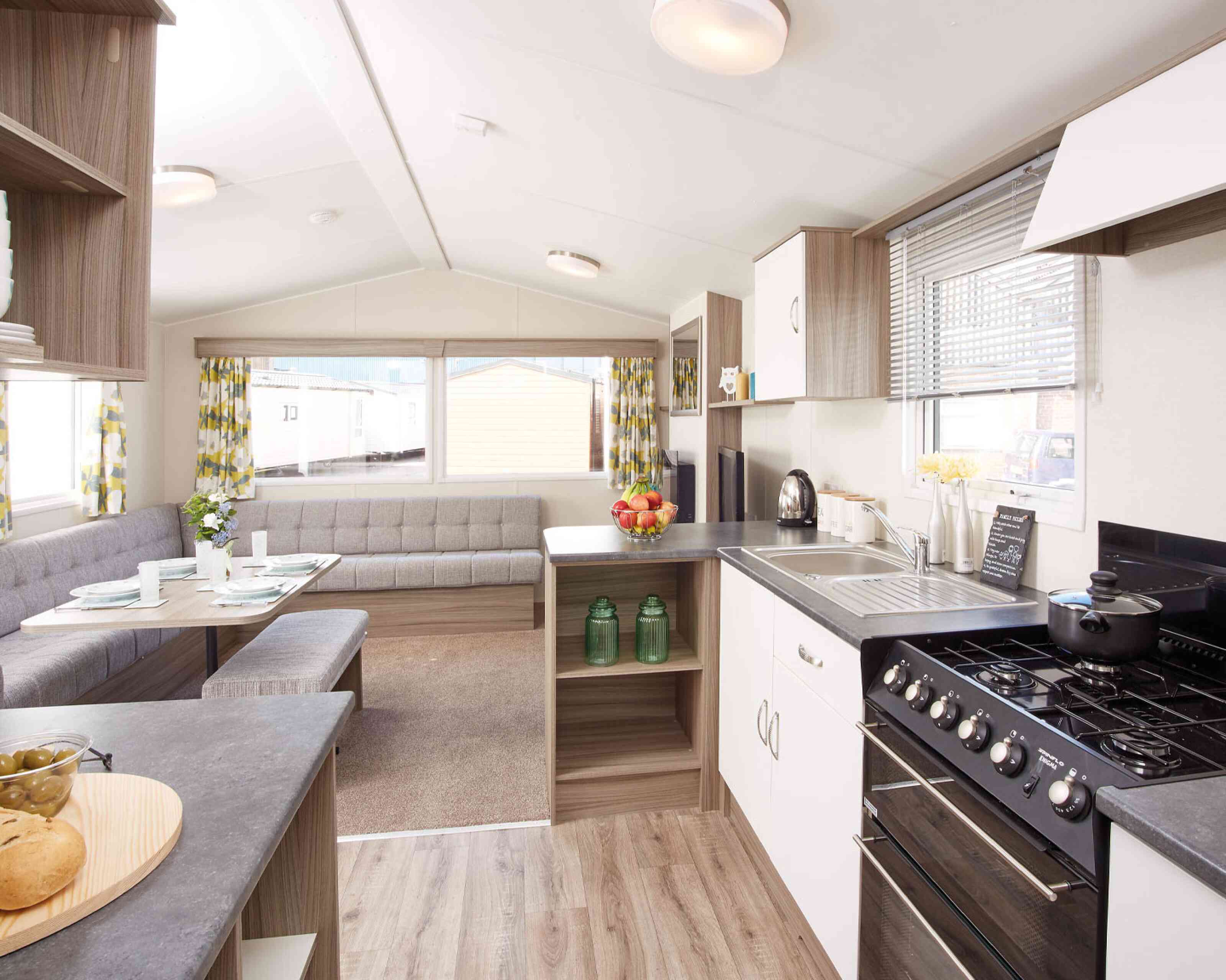 A kitchen scene displaying a stove alongside a table, emphasizing the cooking and dining areas.