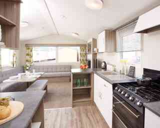 A kitchen scene displaying a stove alongside a table, emphasizing the cooking and dining areas.