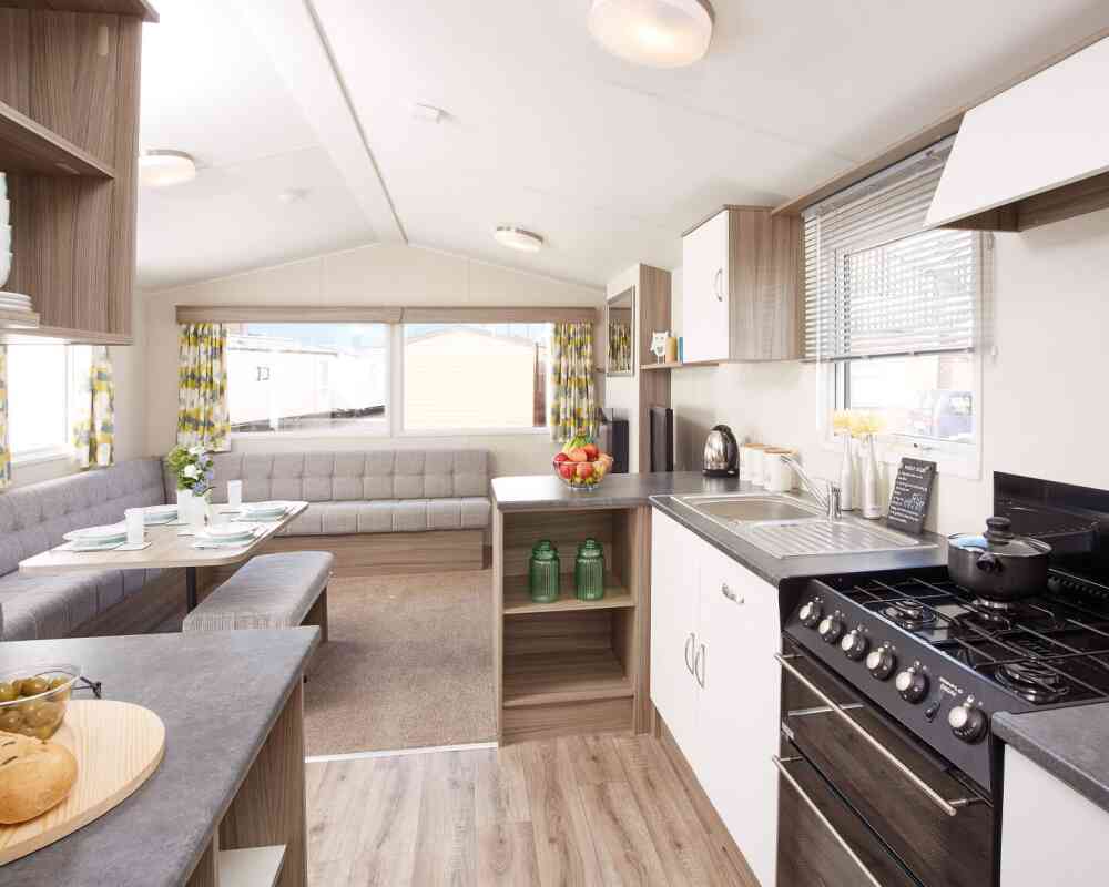 A kitchen scene displaying a stove alongside a table, emphasizing the cooking and dining areas.