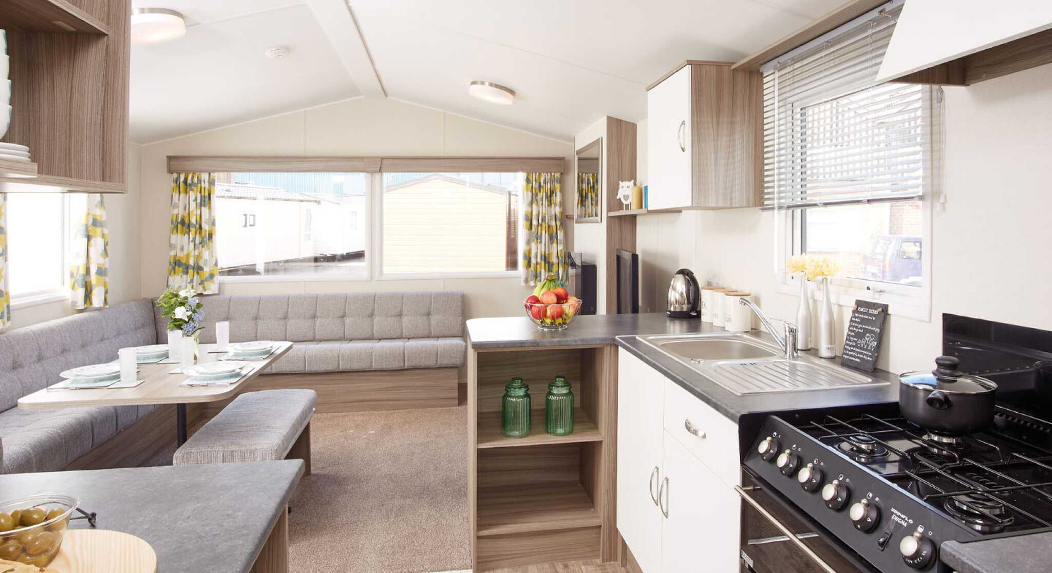A kitchen scene displaying a stove alongside a table, emphasizing the cooking and dining areas.