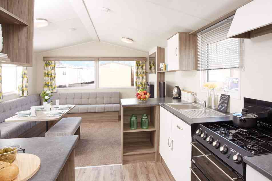 A kitchen scene displaying a stove alongside a table, emphasizing the cooking and dining areas.