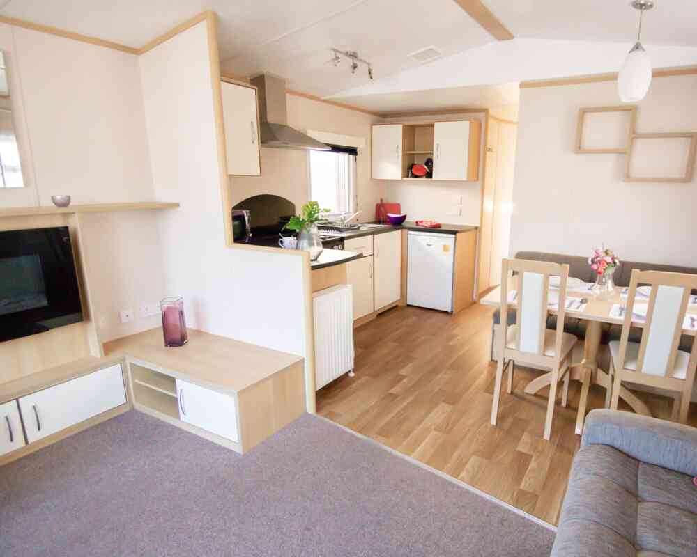 A modern kitchen and dining area with comfortable seating arrangement and a sleek table, designed for relaxation and socializing.