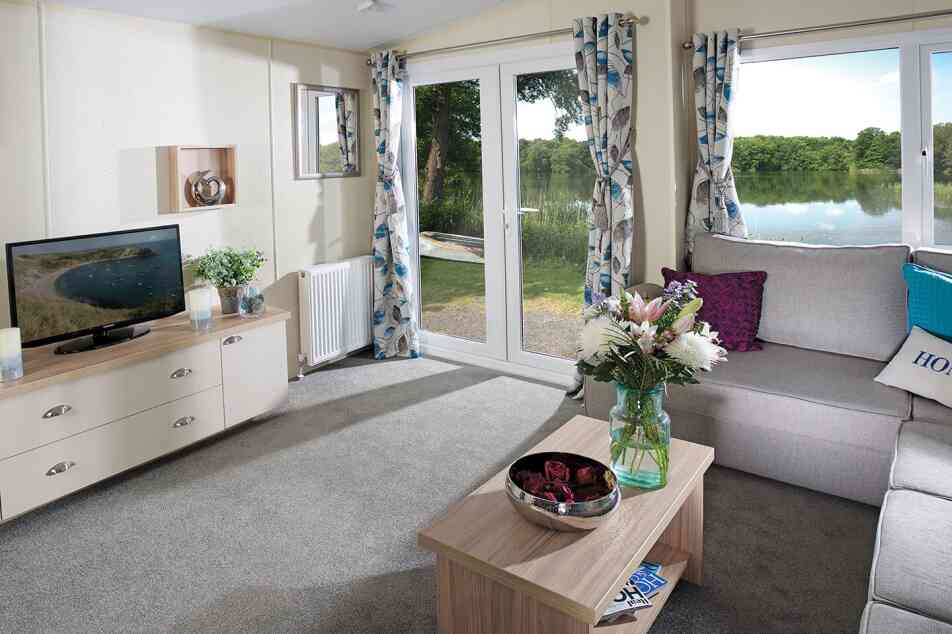 A stylish living room showcasing a couch, a coffee table, and a television, creating a welcoming atmosphere.