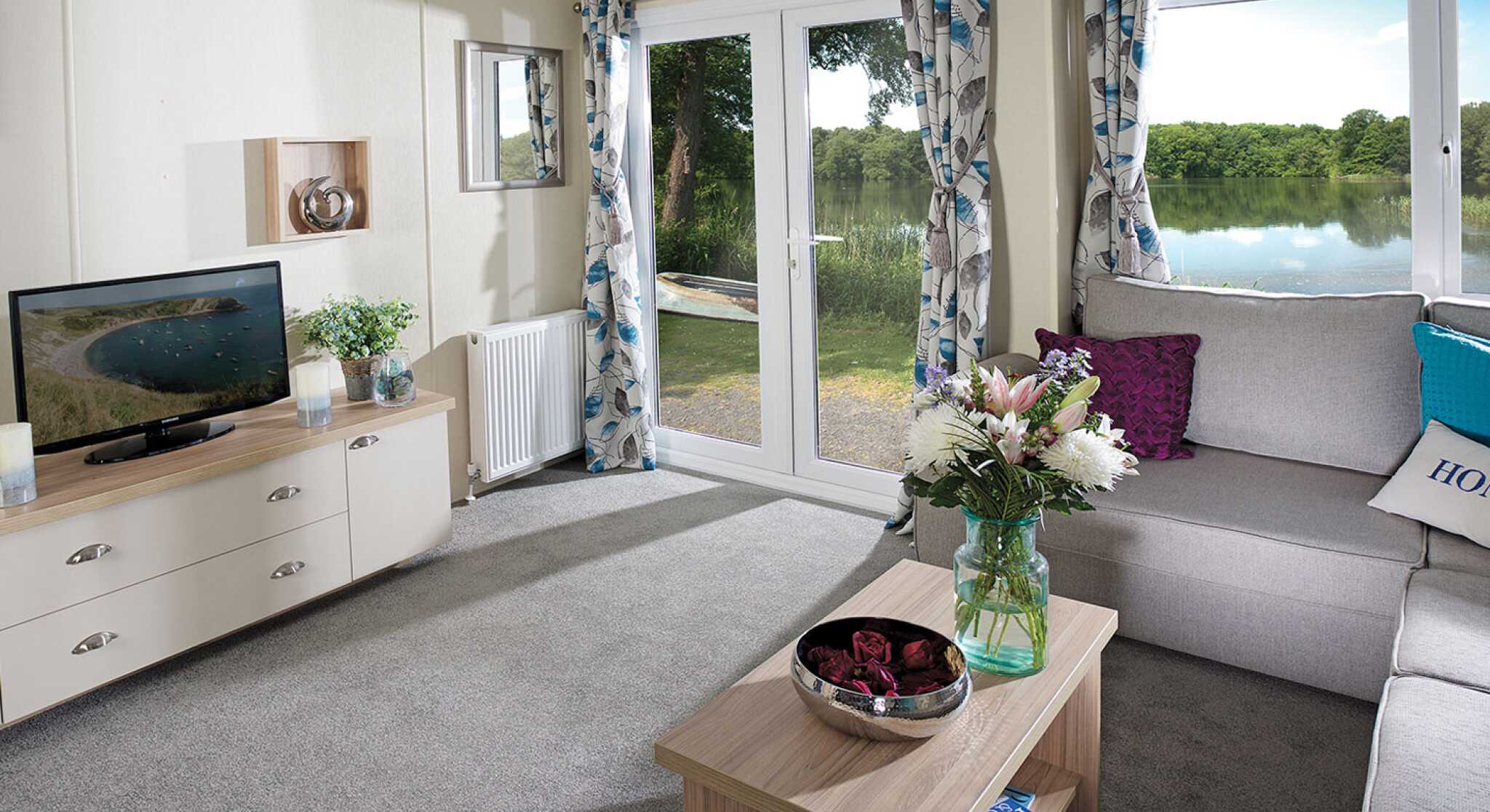 A stylish living room showcasing a couch, a coffee table, and a television, creating a welcoming atmosphere.