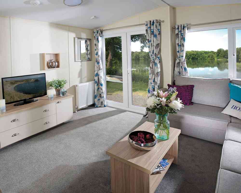 A stylish living room showcasing a couch, a coffee table, and a television, creating a welcoming atmosphere.