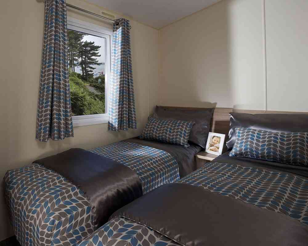 A bedroom featuring two beds and a window that offers a beautiful view of the outdoors.