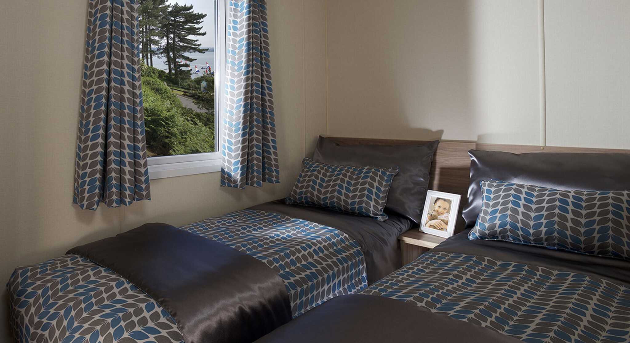 A bedroom featuring two beds and a window that offers a beautiful view of the outdoors.
