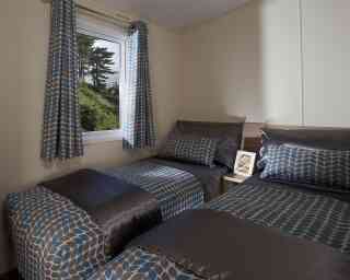 A bedroom featuring two beds and a window that offers a beautiful view of the outdoors.