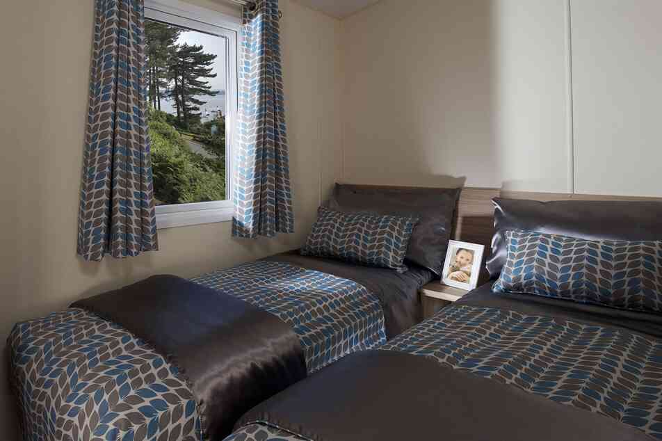 A bedroom featuring two beds and a window that offers a beautiful view of the outdoors.