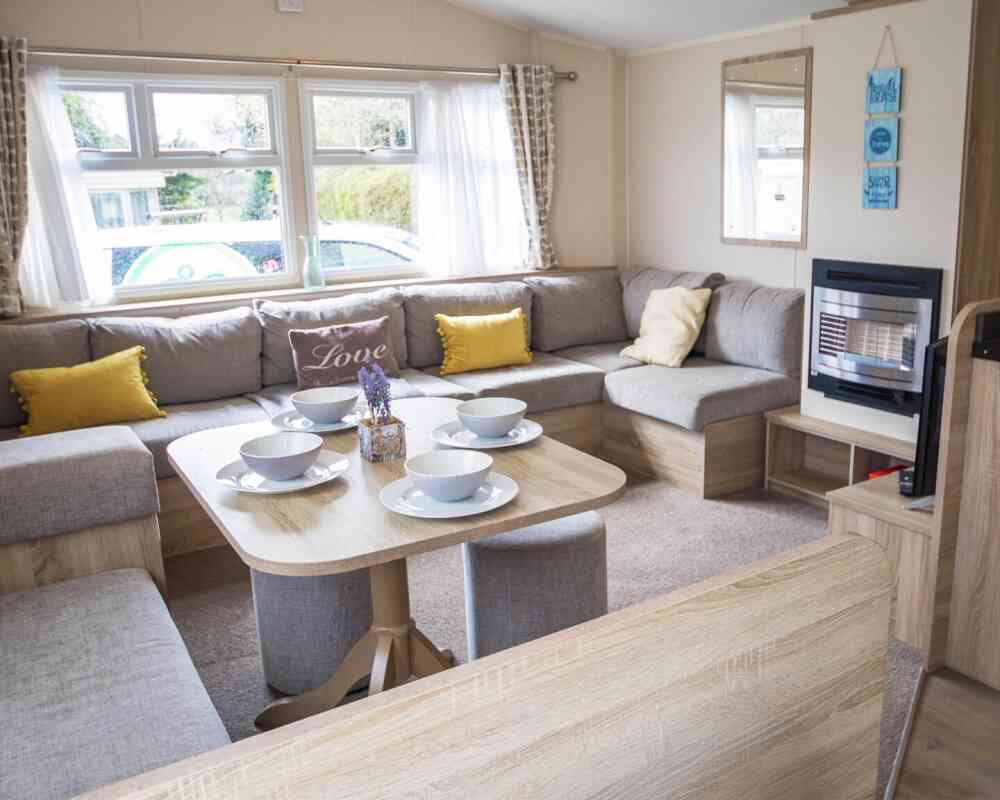 A stylish living room showcasing a couch, a table, and chairs, creating an inviting atmosphere for gatherings.