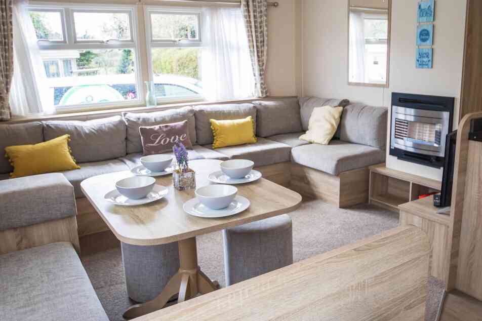 A stylish living room showcasing a couch, a table, and chairs, creating an inviting atmosphere for gatherings.