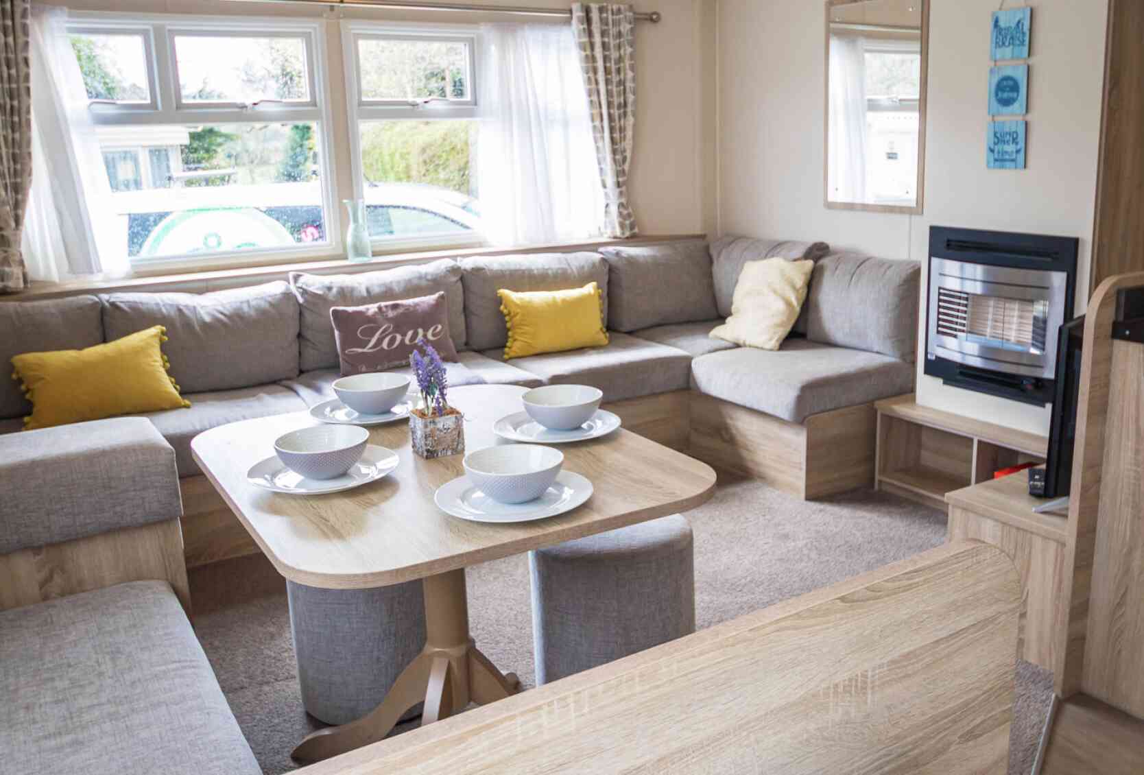 A stylish living room showcasing a couch, a table, and chairs, creating an inviting atmosphere for gatherings.