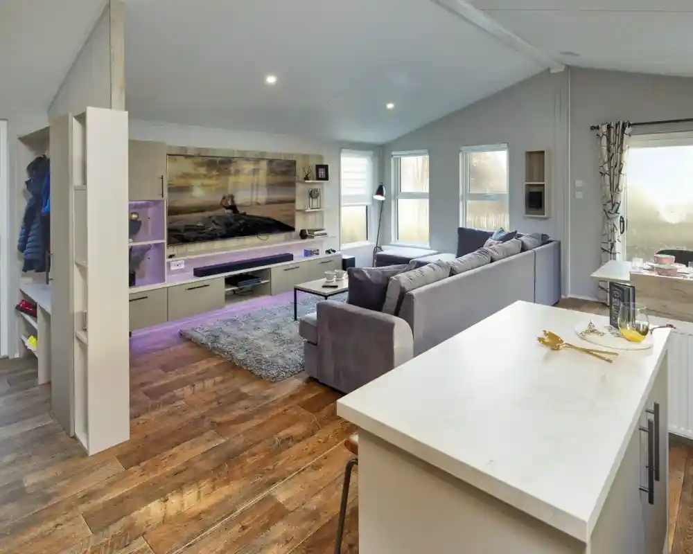 Modern living room with large sectional sofa, entertainment centre, and island breakfast bar.