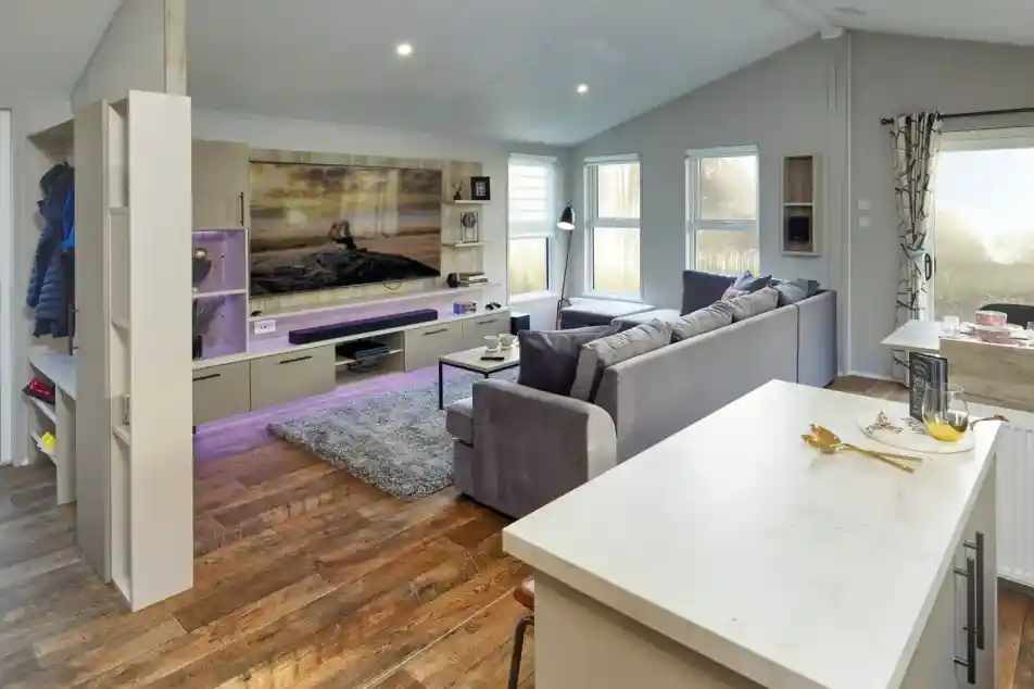 Modern living room with large sectional sofa, entertainment centre, and island breakfast bar.