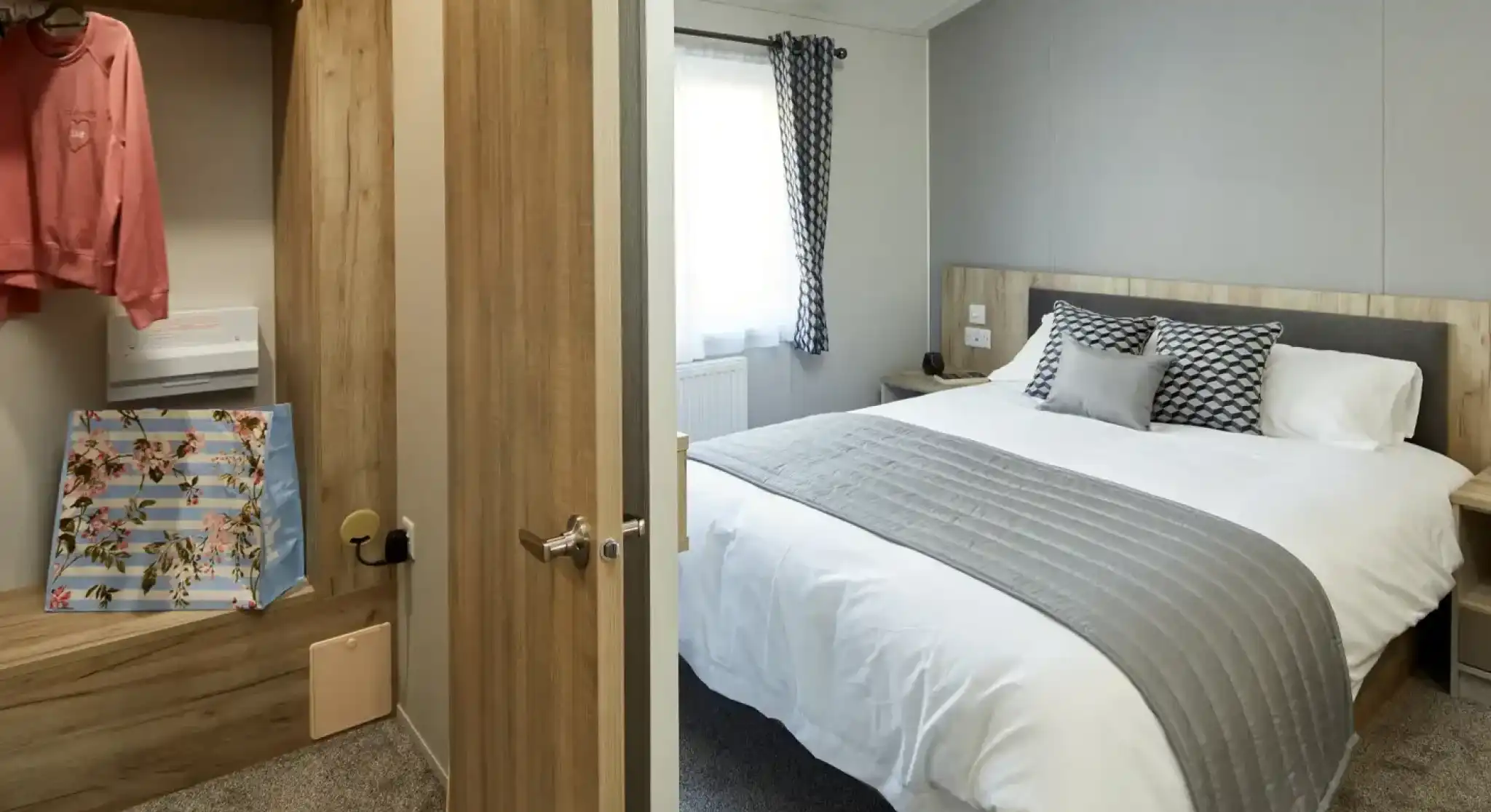 View into a bedroom with a made bed and an adjacent closet with clothing and a floral bag.