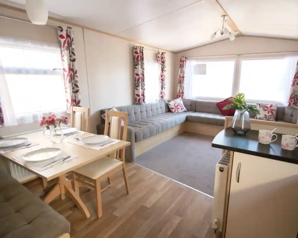 A cosy living area featuring a table surrounded by chairs, creating an inviting space for gatherings.