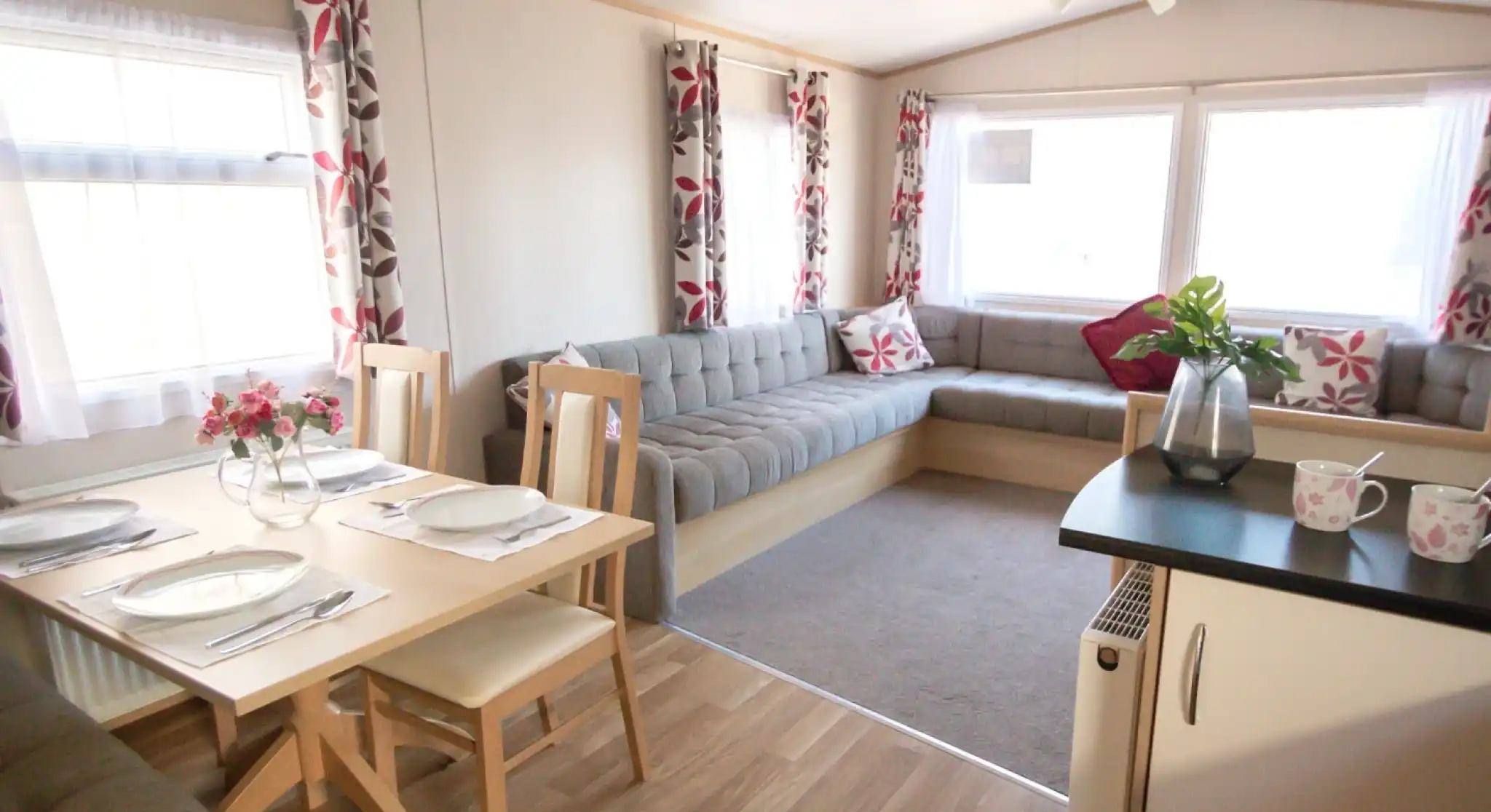 A cosy living area featuring a table surrounded by chairs, creating an inviting space for gatherings.