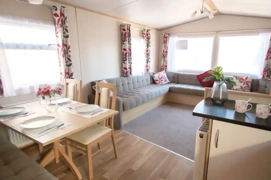 A cosy living area featuring a table surrounded by chairs, creating an inviting space for gatherings.