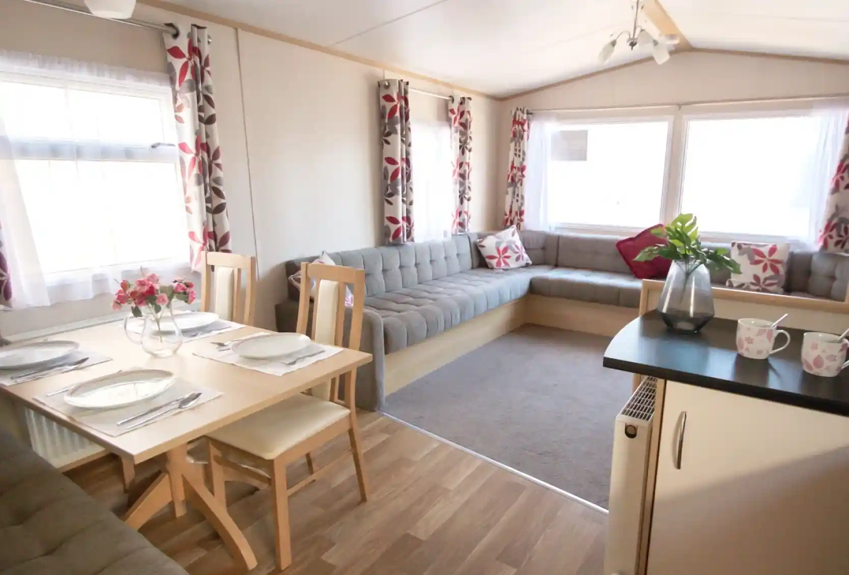 A cosy living area featuring a table surrounded by chairs, creating an inviting space for gatherings.