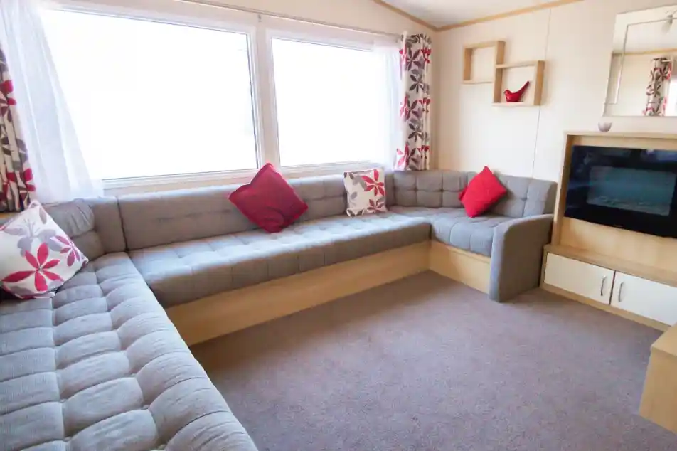 A stylish living room with a couch, a television, and a coffee table, designed for leisure and socializing.