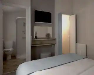 Cozy bedroom with a light blue bedspread, featuring a mounted TV on the wall. A shelf with decorative items sits near a door leading to an ensuite bathroom with a shower and toilet. A second door leads to a small wardrobe, and a radiator is visible on the wall.