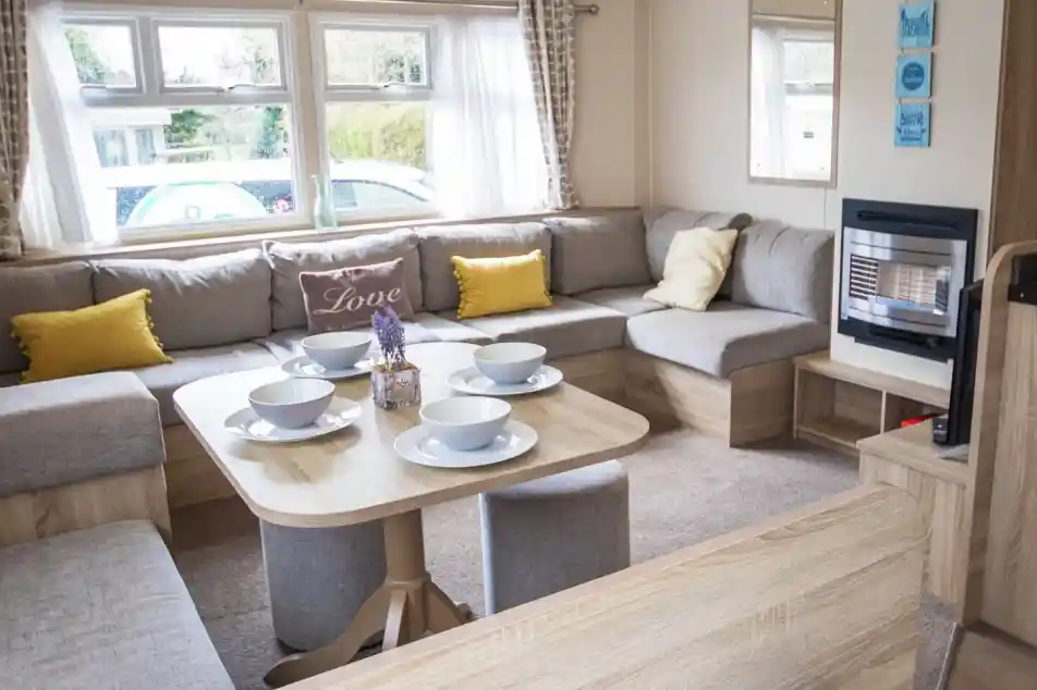 A stylish living room showcasing a couch, a table, and chairs, creating an inviting atmosphere for gatherings.