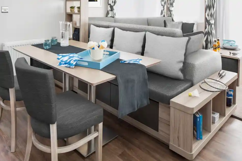Modern dining area with a dining table, bench seating and integrated shelving.