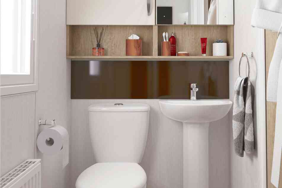 Light and airy bathroom with WC and wash hand basin, together with storage above