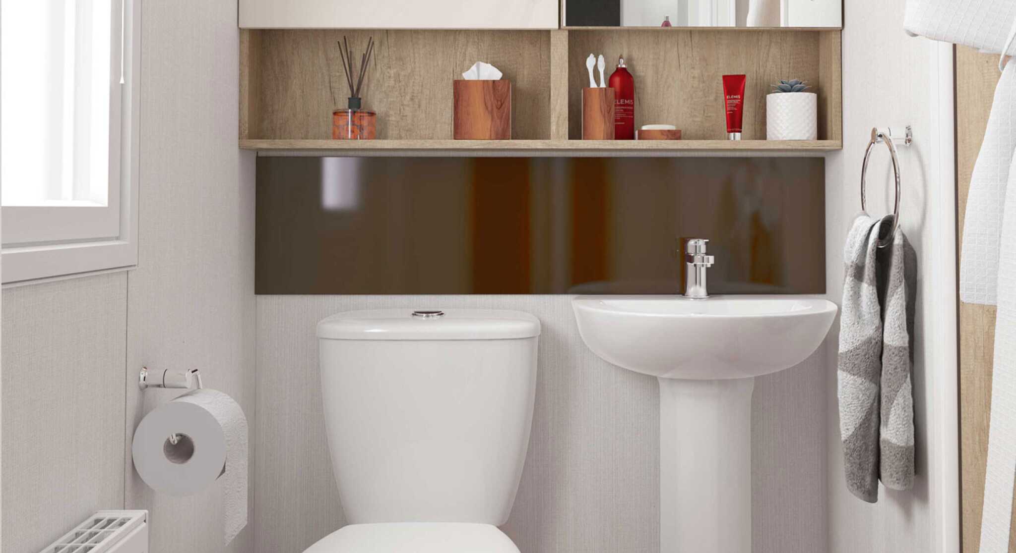 Light and airy bathroom with WC and wash hand basin, together with storage above