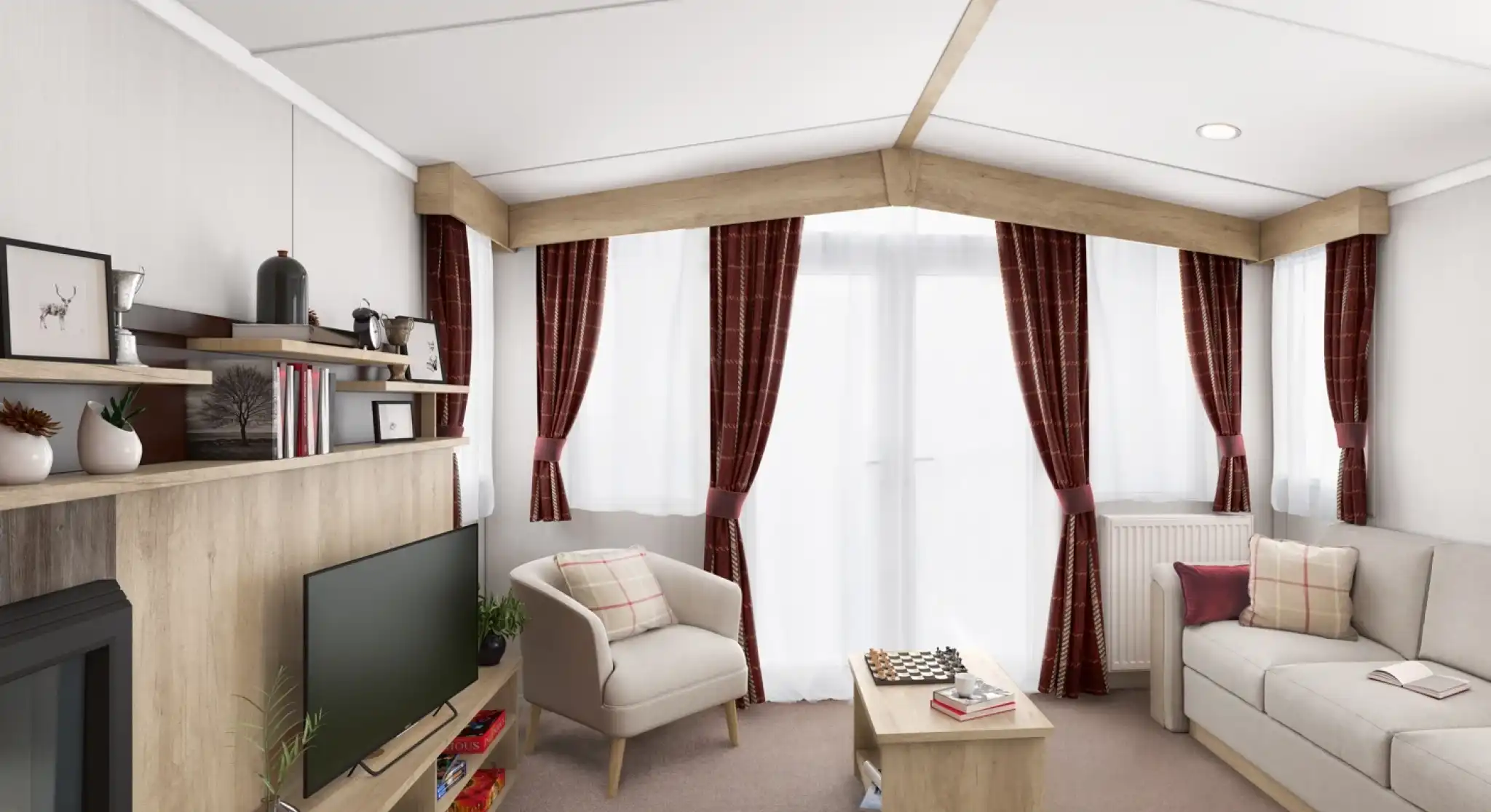 Bright lounge with light colours sofa and tub chair, with a coffee table, TV and fireplace