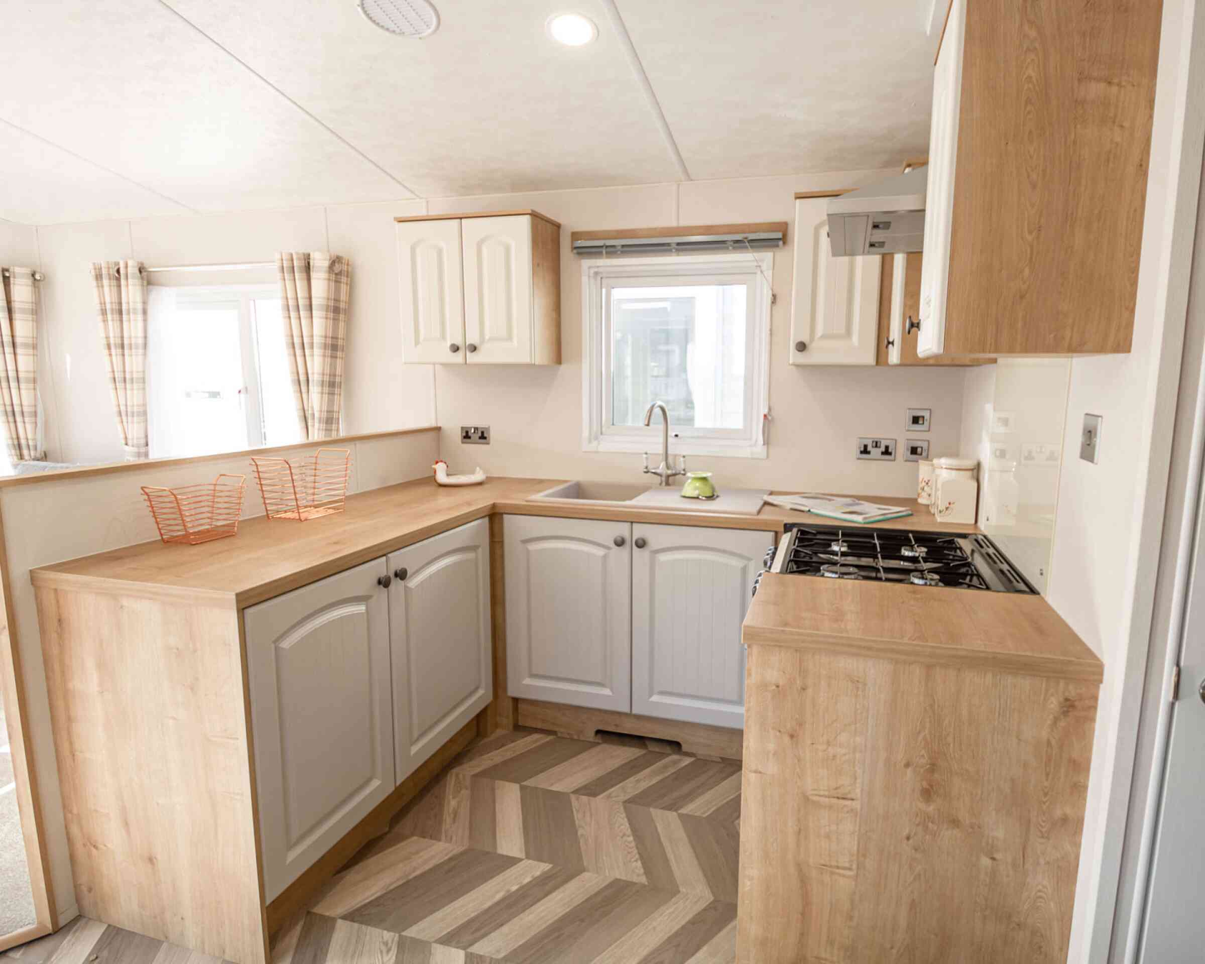 A well-equipped kitchen with a sink, stove, oven and microwave, designed for meal preparation.