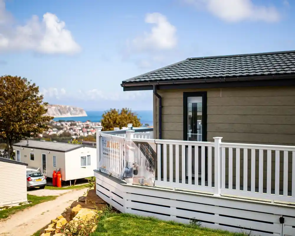 Lodge with decking overlooking Swanage bay on a sunny day