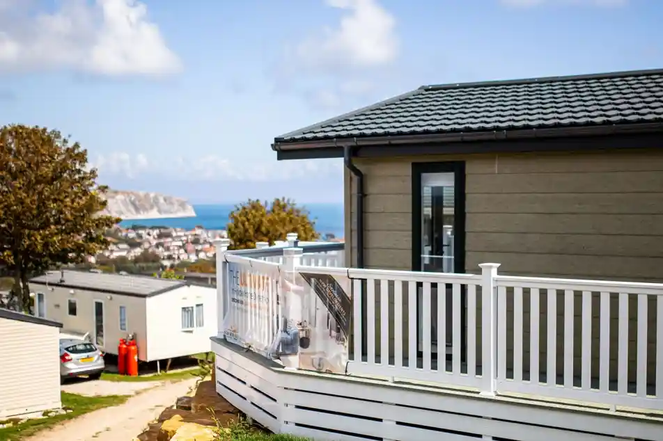 Lodge with decking overlooking Swanage bay on a sunny day