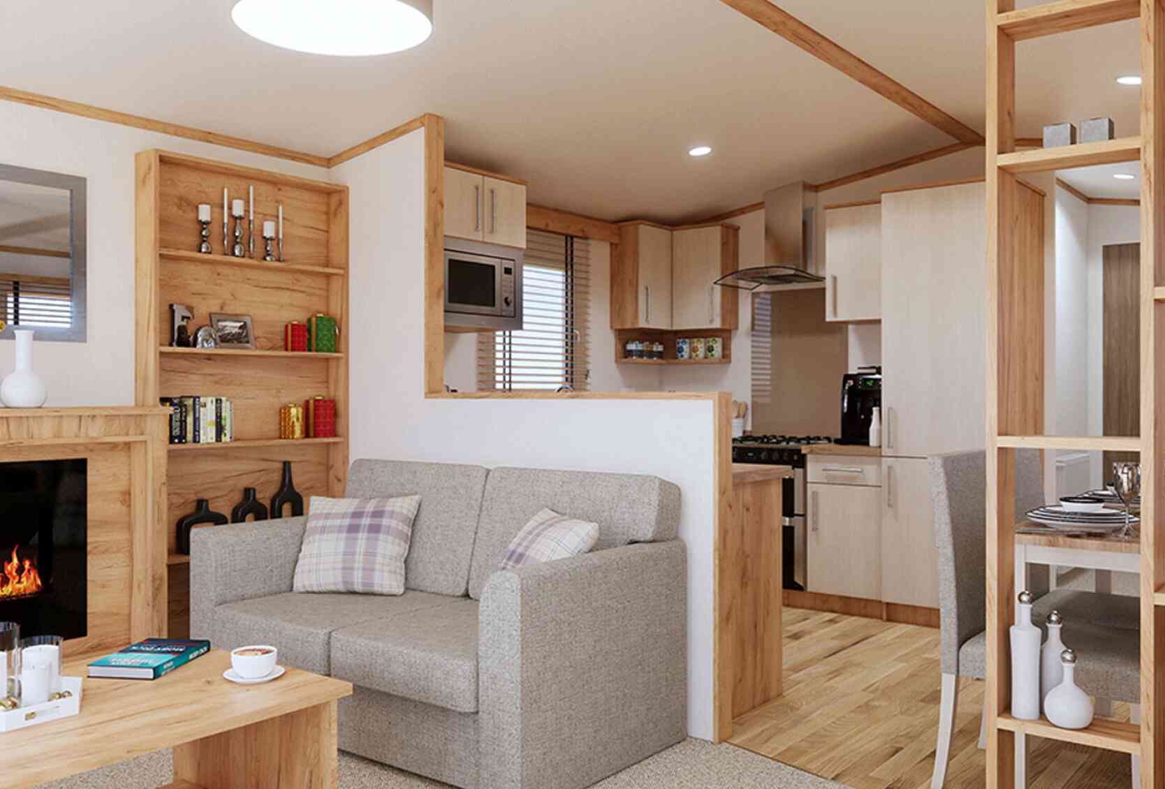 A stylish open plan living room with a comfortable sofa, a coffee table, and a fireplace, perfect for relaxation and gatherings.