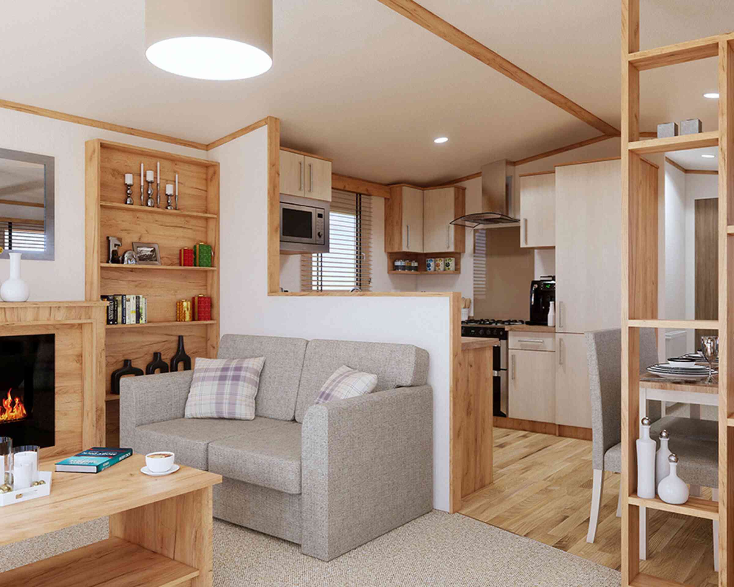 A stylish open plan living room with a comfortable sofa, a coffee table, and a fireplace, perfect for relaxation and gatherings.