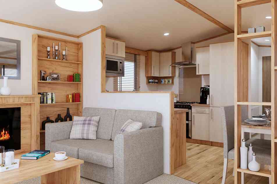 A stylish open plan living room with a comfortable sofa, a coffee table, and a fireplace, perfect for relaxation and gatherings.