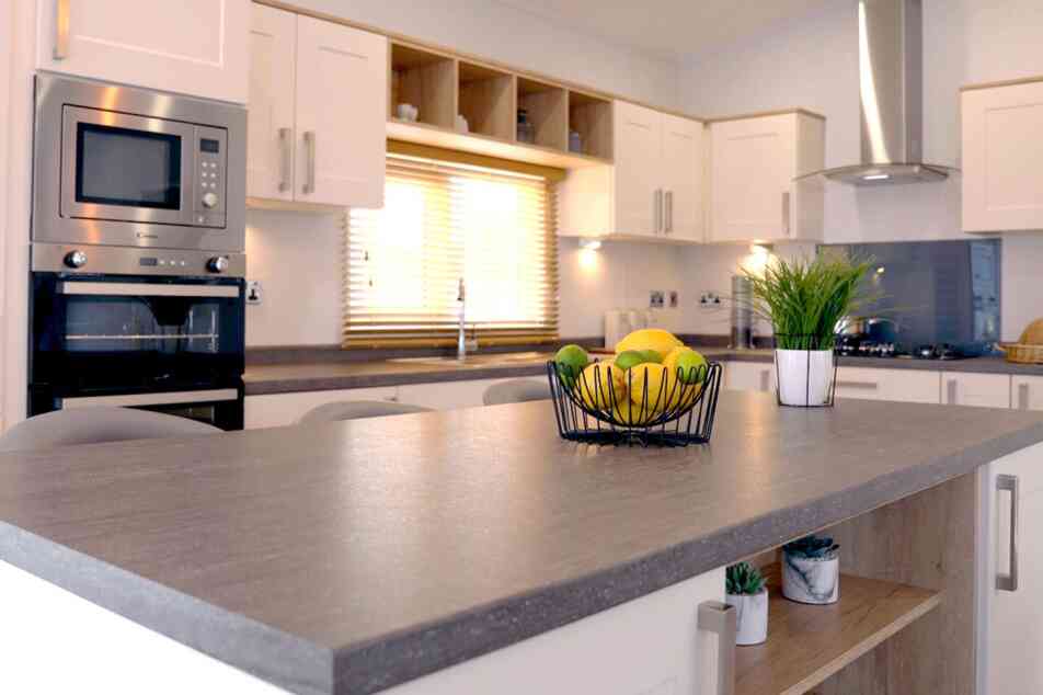 A well-designed kitchen displaying a counter top and sink, highlighting an efficient and practical cooking area.